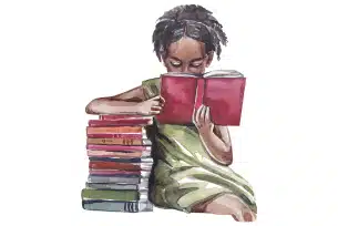 A young girl sits next to a stack of books, deeply focused on reading a red book.